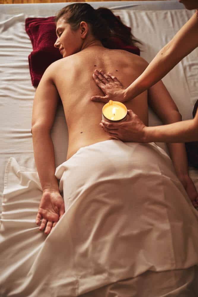 hand-of-massage-therapist-spreading-wax-on-female-2022-01-18-23-34-12-utc
